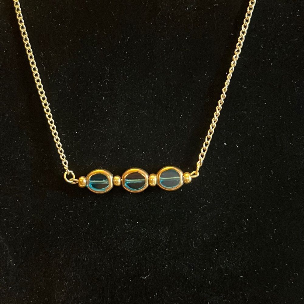 Handcrafted Gold tone 20 inch necklace with added extender. Blue and gold beads.